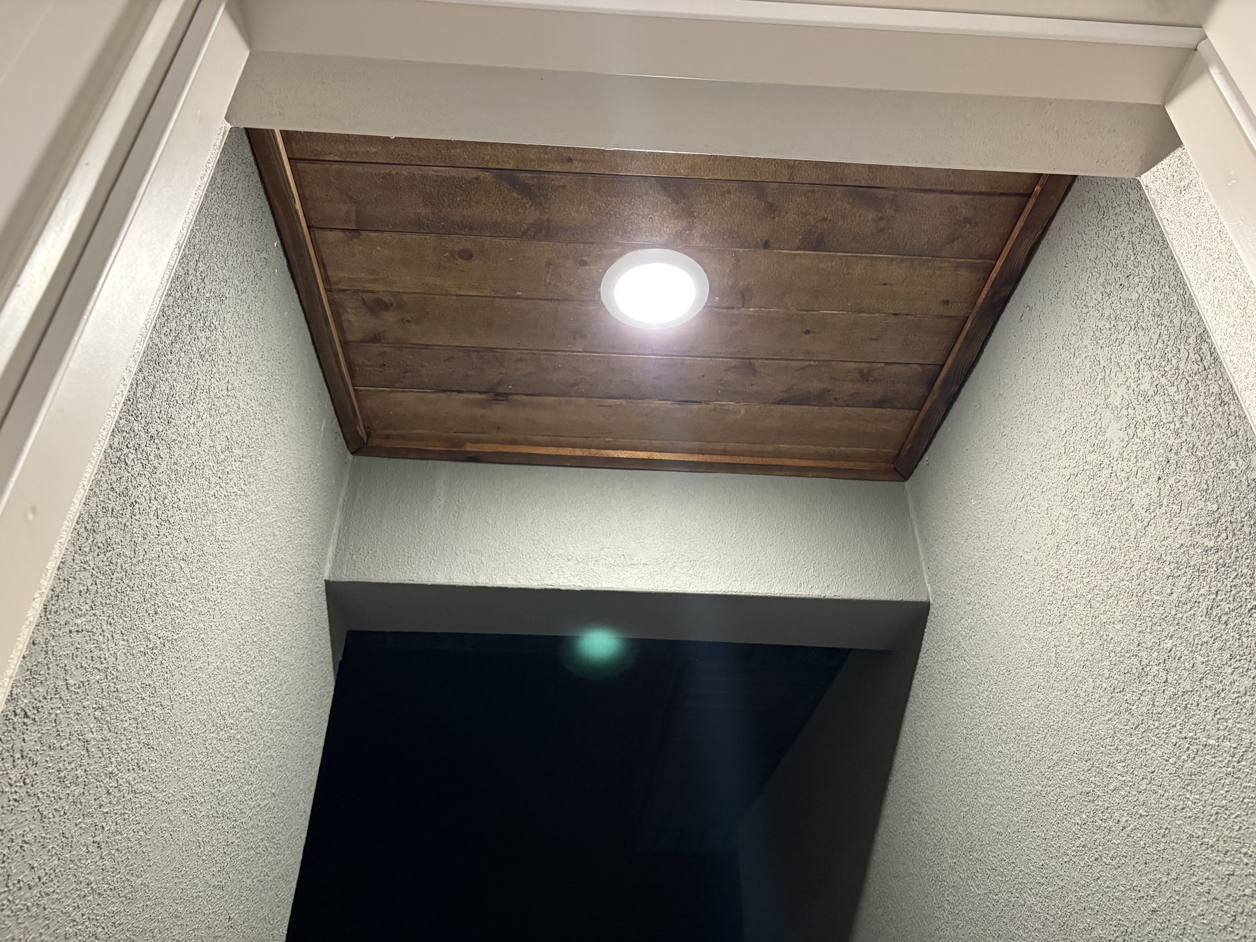 Stained wood entry ceiling detail by KDP Builders